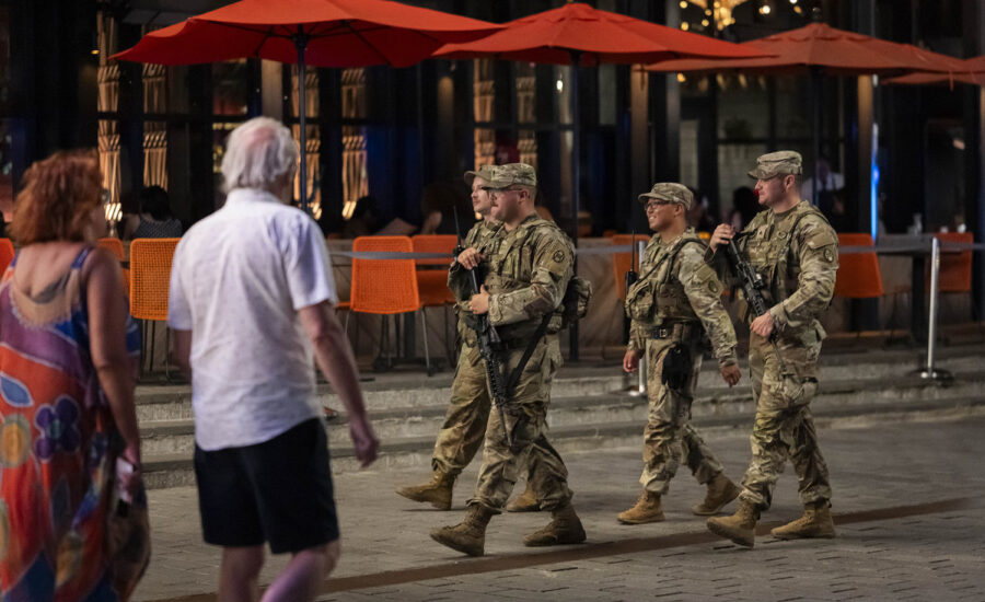 National Guard troops begin carrying firearms in Washington